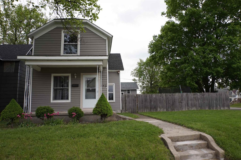 Front of home features large privacy fenced in yar