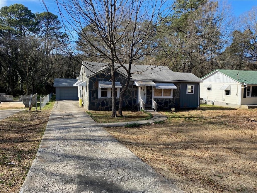 View of front of home with an outbuilding, stone s
