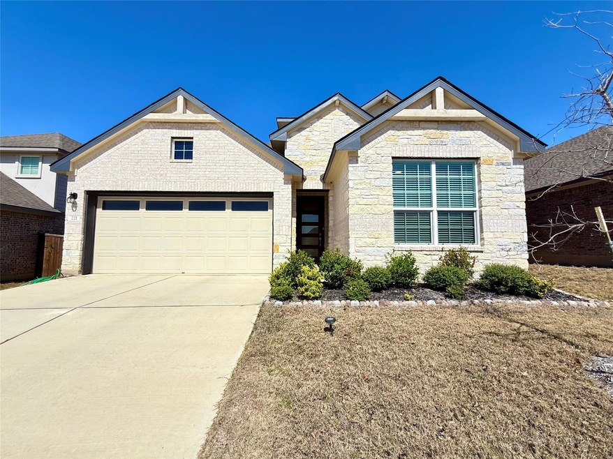 View of front of home with an attached garage, st
