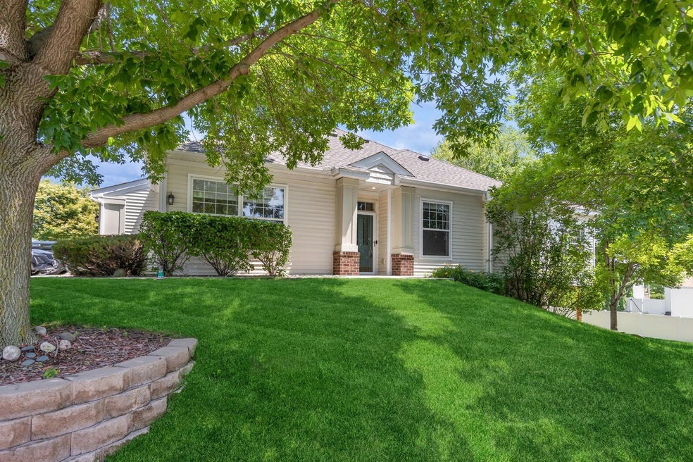Side view of the home showcasing the main entry and charming sidewalk.