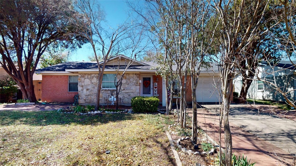 Single story home featuring stone siding, brick si