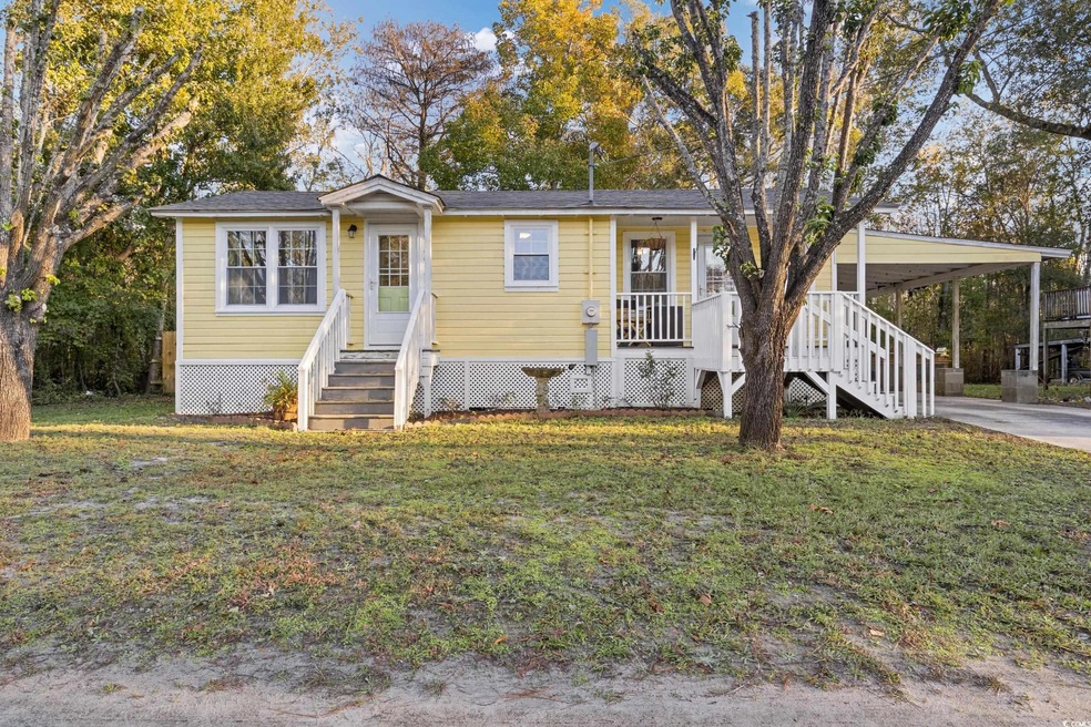 View of front facade with a front lawn, a porch, a
