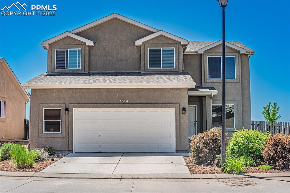 View of front of home with stucco siding, a garage, and concrete driveway
