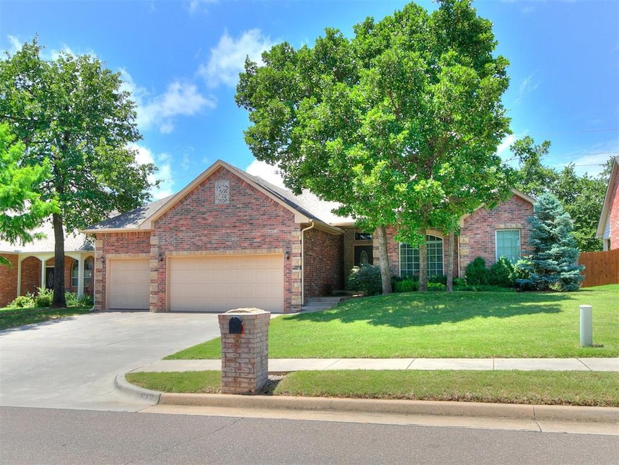 View of front facade with a garage, brick siding, and concrete driveway
