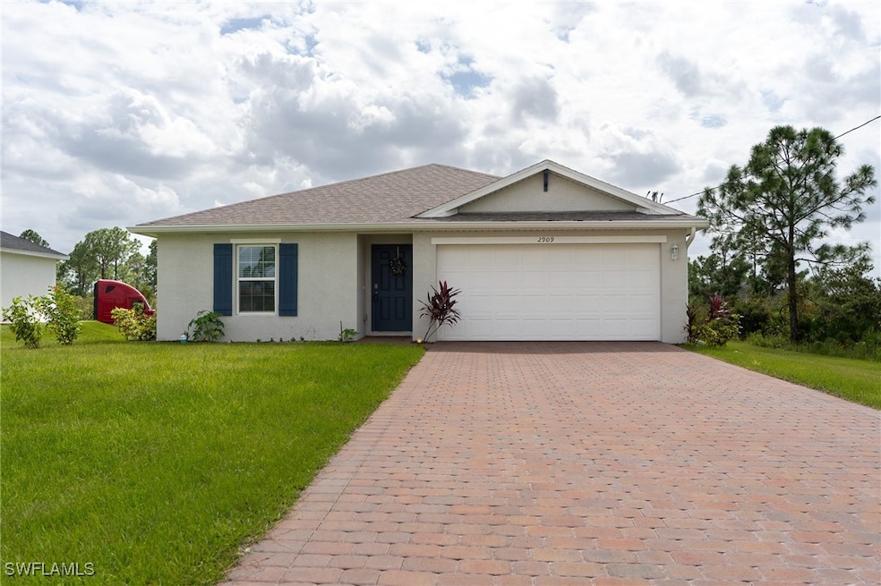 Single story home featuring a garage and a front l