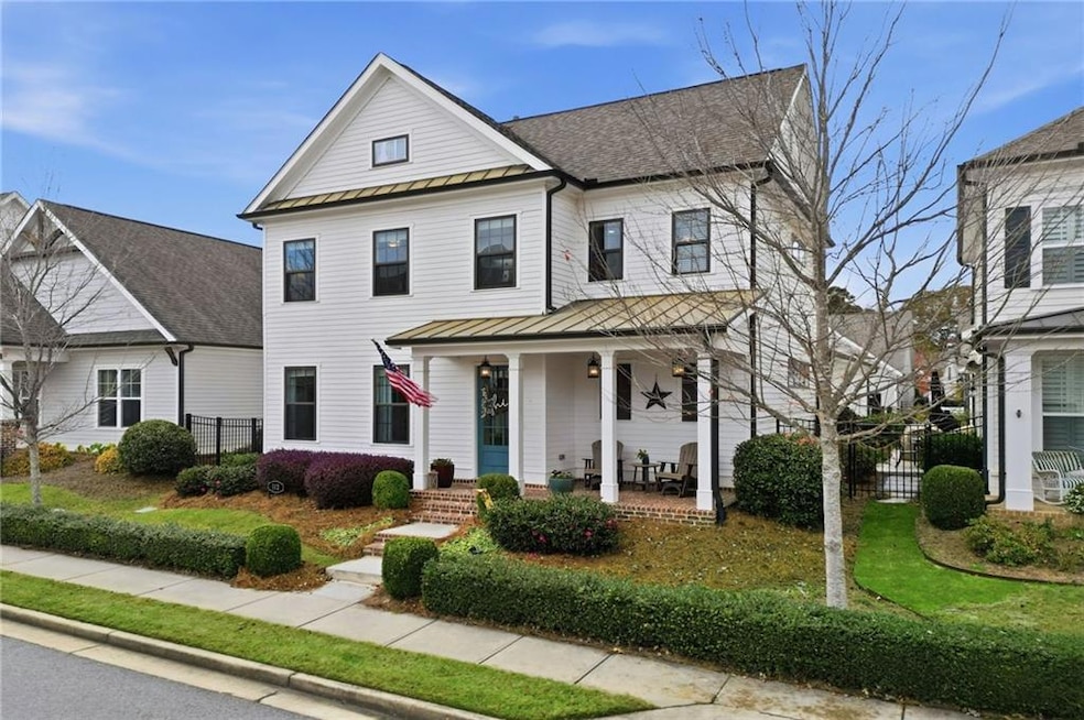 View of front of house featuring a standing seam roof, covered porch, and a metal roof