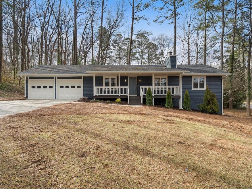 Ranch-style home with a garage and covered porch