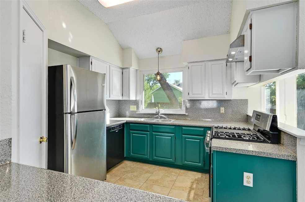 Kitchen with green cabinetry, stainless steel app