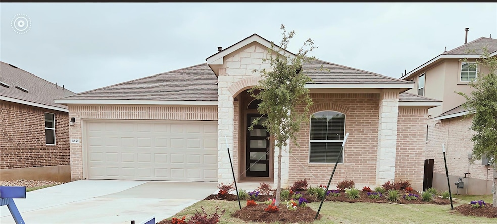 View of front of property featuring brick siding, driveway, a garage, and roof with shingles