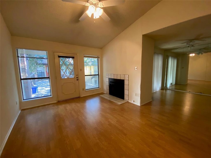 Unfurnished living room featuring a ceiling fan, 