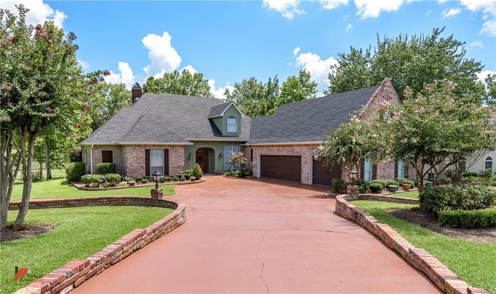 Lush landscaping adds to the charm of this home an