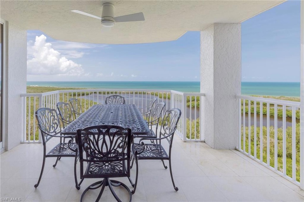 Balcony with a water view, ceiling fan, and outdoor dining space