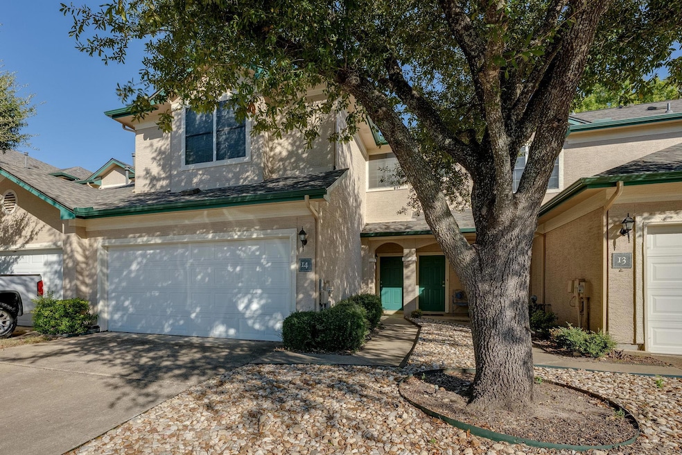 View of front facade with stucco siding, concrete driveway, an attached garage, and roof with shingles