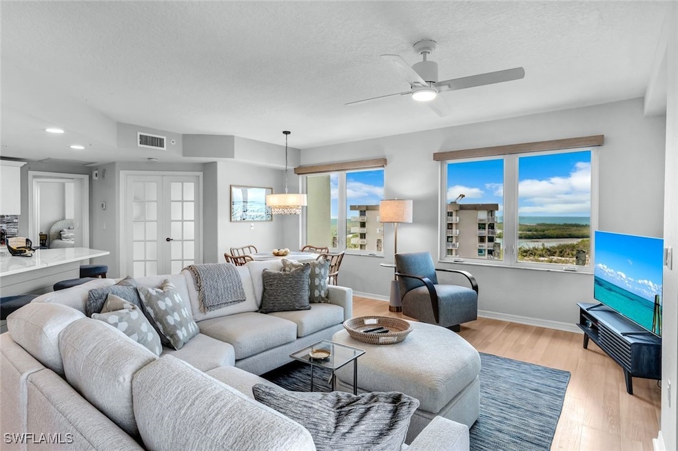Living area with visible vents, baseboards, light