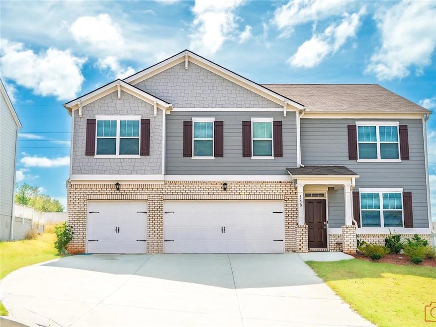 Craftsman house with brick siding, driveway, and a garage