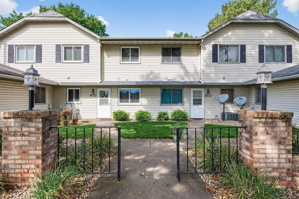 Front Exterior Charming two-story Manor-style townhome with a welcoming gated courtyard and low-maintenance exterior.