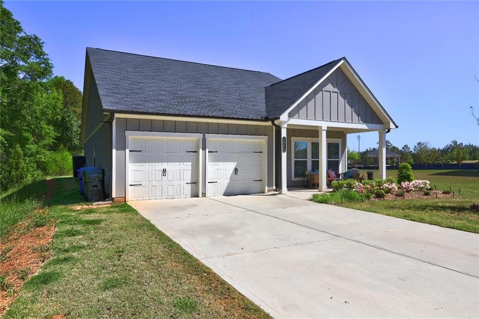 View of front of home with roof with shingles, a f
