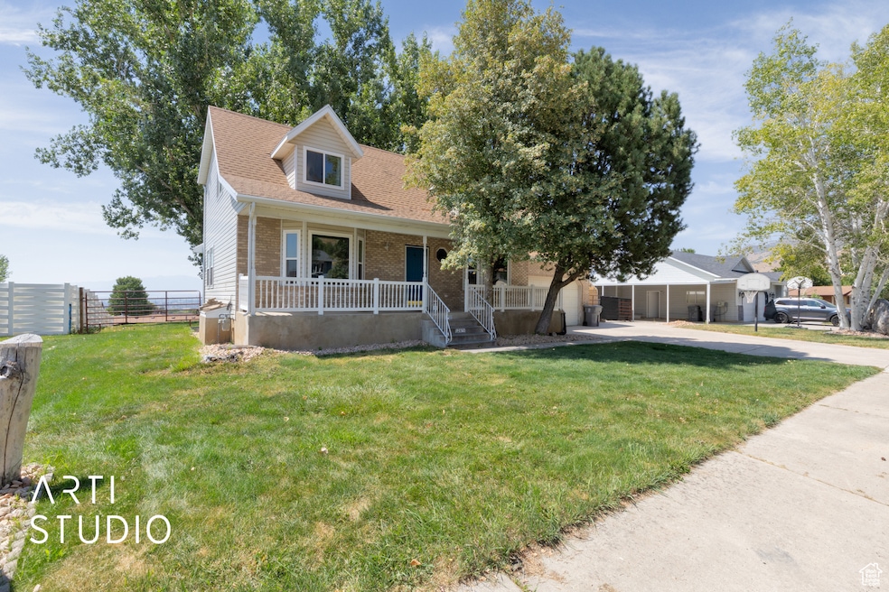 Cape cod home with a porch, brick siding, concrete driveway, a front lawn, and roof with shingles