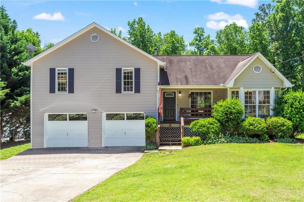 View of front of home with a front lawn and a gara
