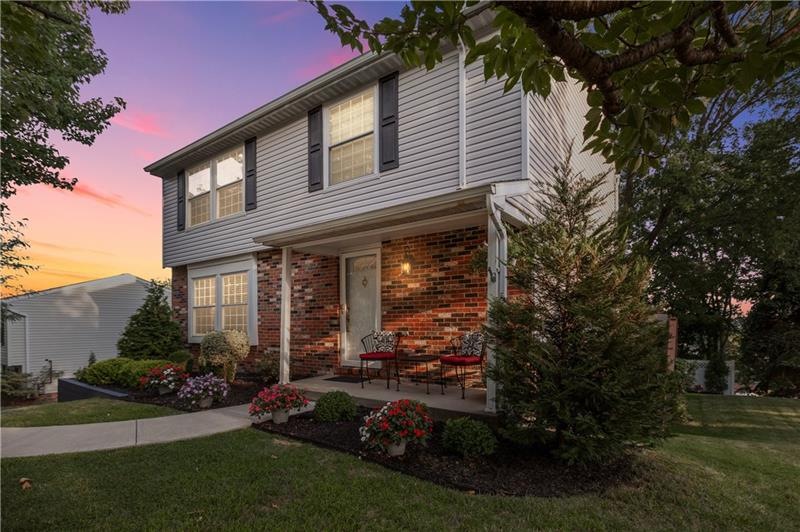 Beautifully landscaped front porch ready for sunse