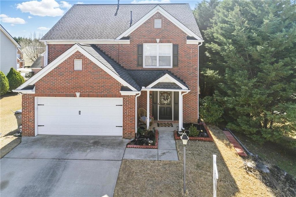 Traditional-style home with brick siding, driveway
