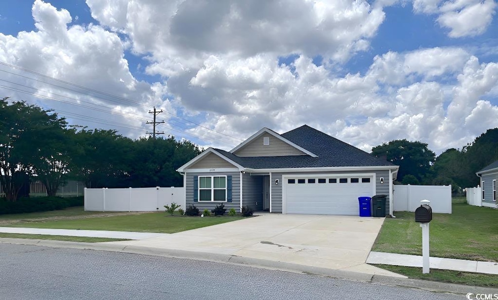 Ranch-style home with an attached garage, concrete driveway, and a shingled roof