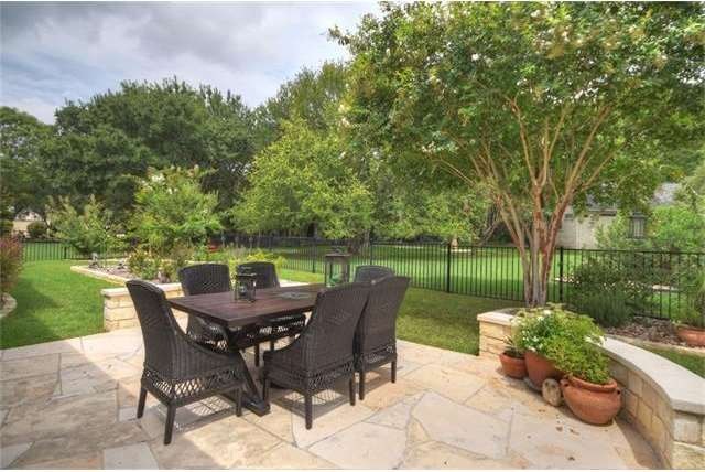 An extended flagstone patio sits outside the scree