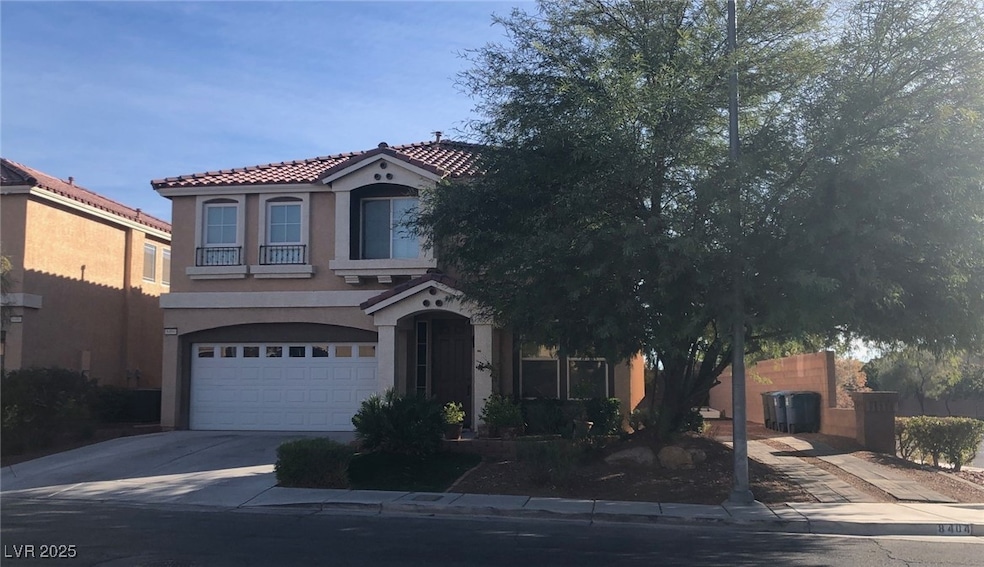 Mediterranean / spanish house featuring stucco siding, driveway, an attached garage, and a tiled roof