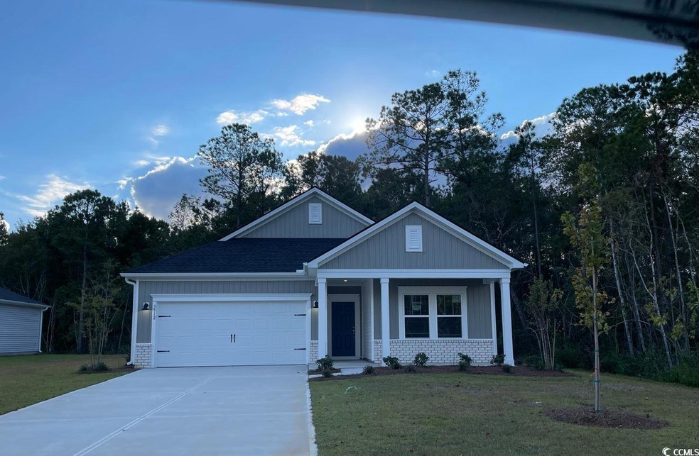 View of front of house with a garage and a front y
