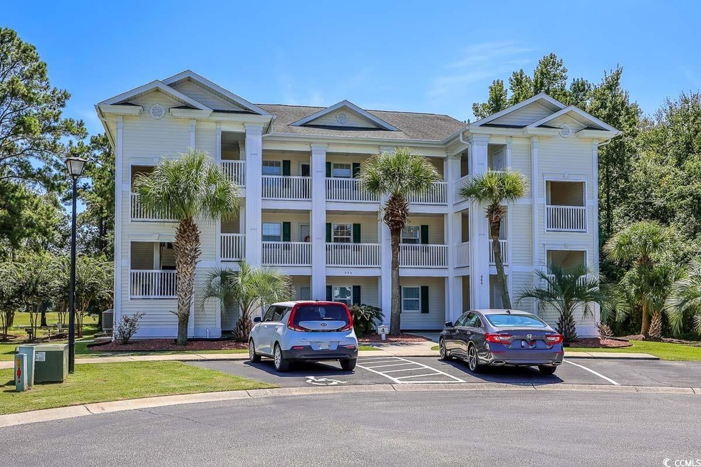 View of building exterior with uncovered parking
