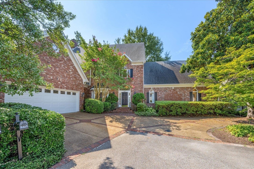 View of front facade featuring concrete driveway, roof with shingles, a garage, and brick siding