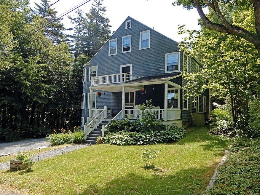 Front of house with lawn and parking...