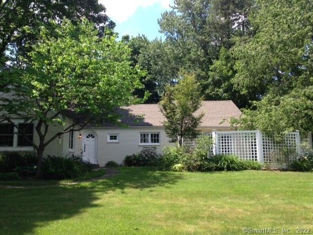 Front view of '40's home shows latticed enclosed t