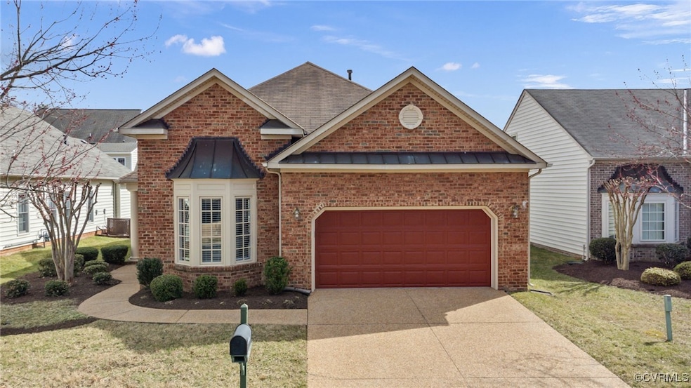 Traditional home with brick siding, concrete drive