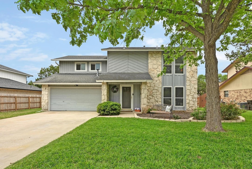 View of front of property with stone siding, conc