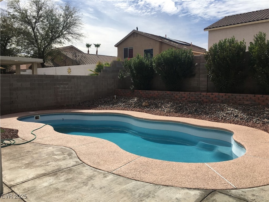 View of pool featuring a fenced backyard and a patio