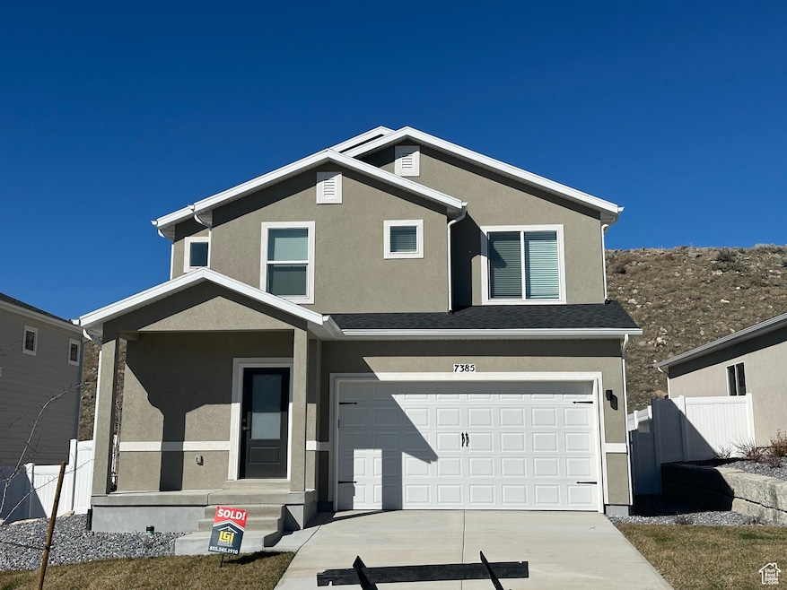 View of front of house with stucco siding, a porch, concrete driveway, and a garage