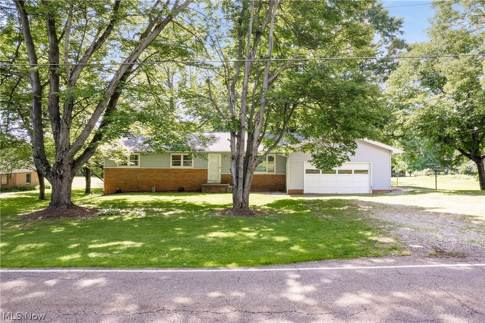 View of front of home featuring a garage and a front lawn