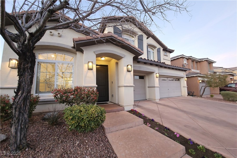 View of front facade with stucco siding, a garage,