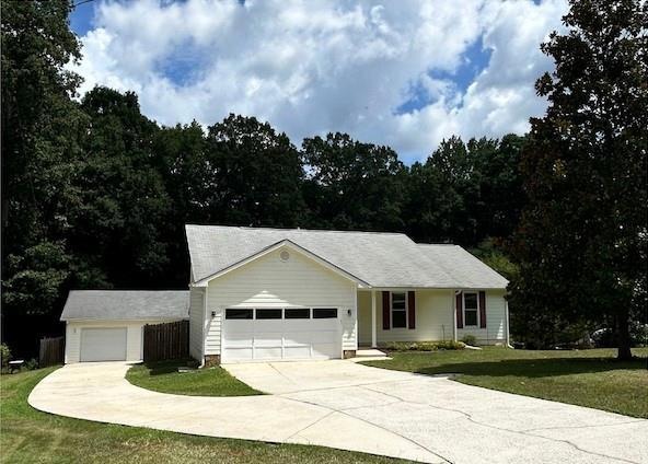 Single story home with concrete driveway and  attached garage, 2nd stand alone garage with sep. power.