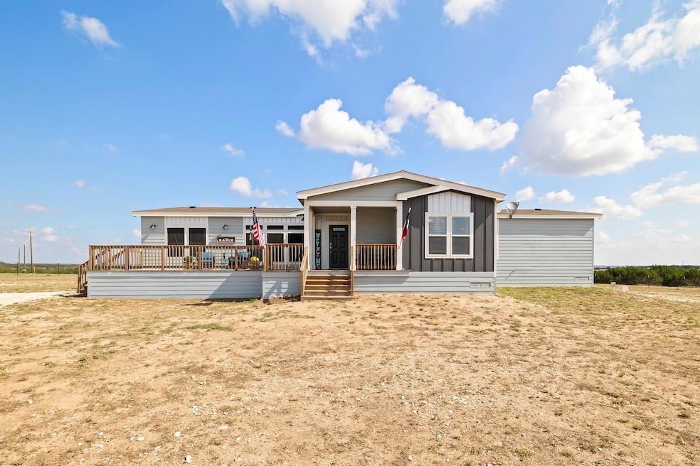 Rear view of house featuring a porch and board an