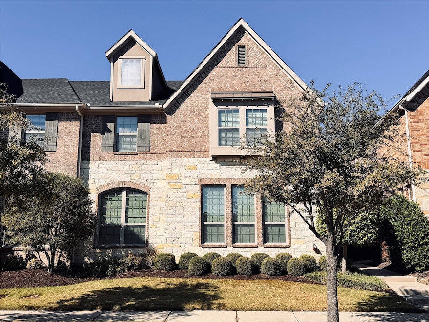 View of front of property with stone siding and brick siding