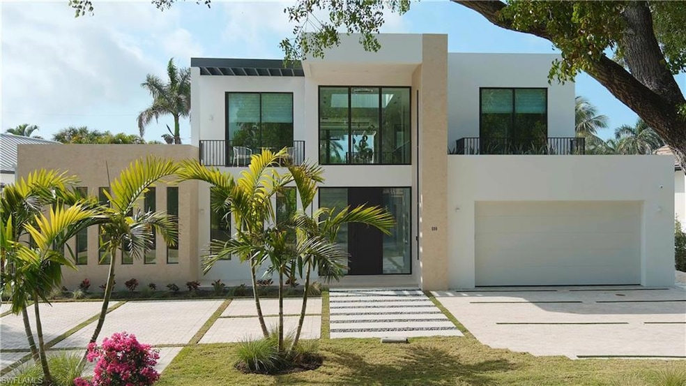 Modern home featuring a garage and a balcony