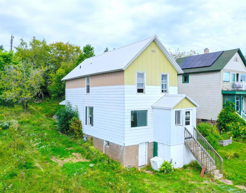 View of property exterior with solar panels and a 