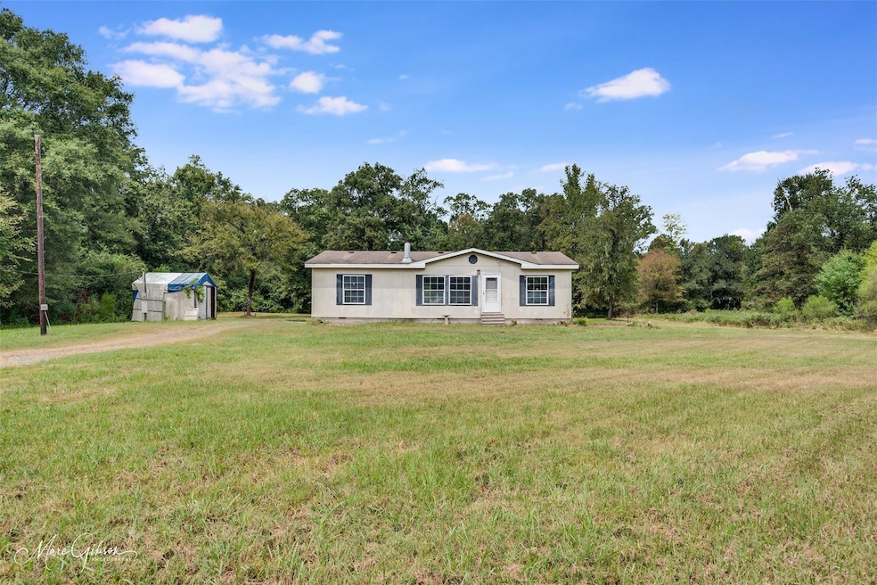 View of front facade with a shed and a front yard