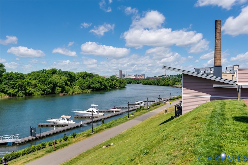 Dock with a water view and a yard