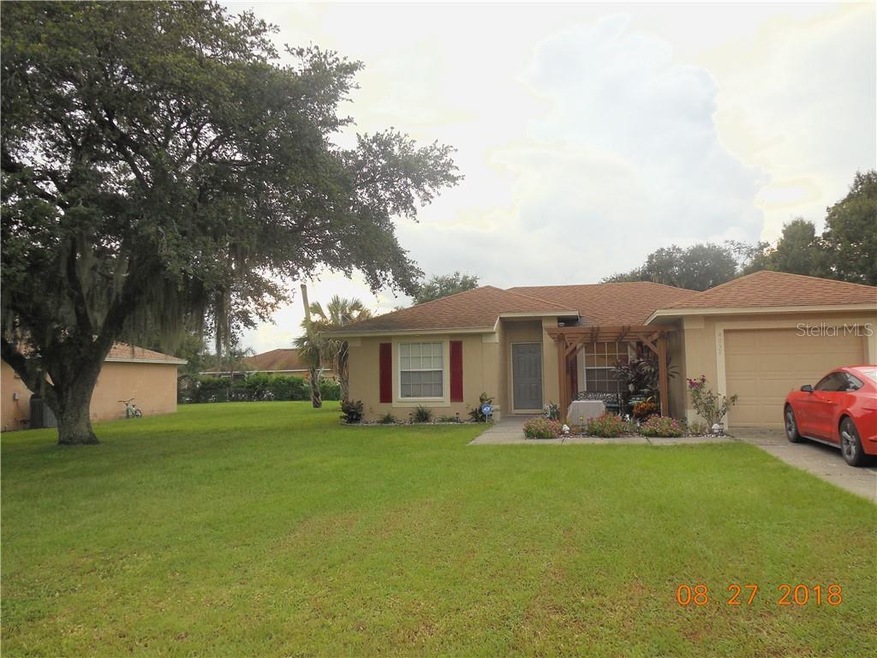 Nice front yard with beautiful Oak tree and landsc