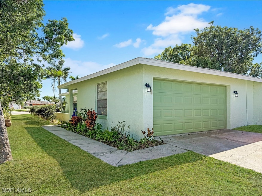 View of property exterior with concrete driveway,