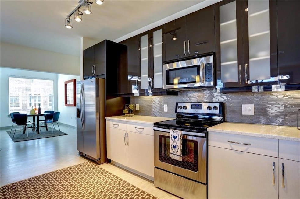 Kitchen featuring decorative backsplash, stainless