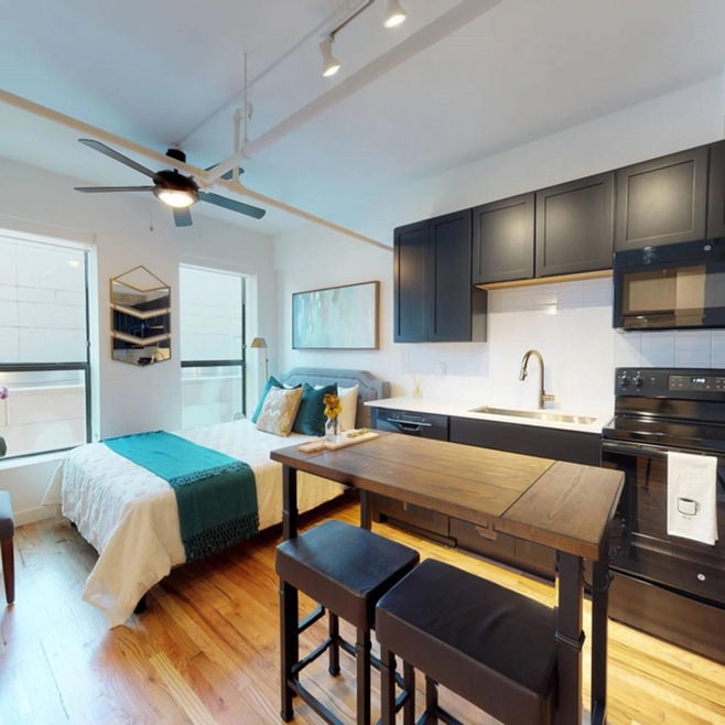 Kitchen featuring black appliances, sink, tasteful